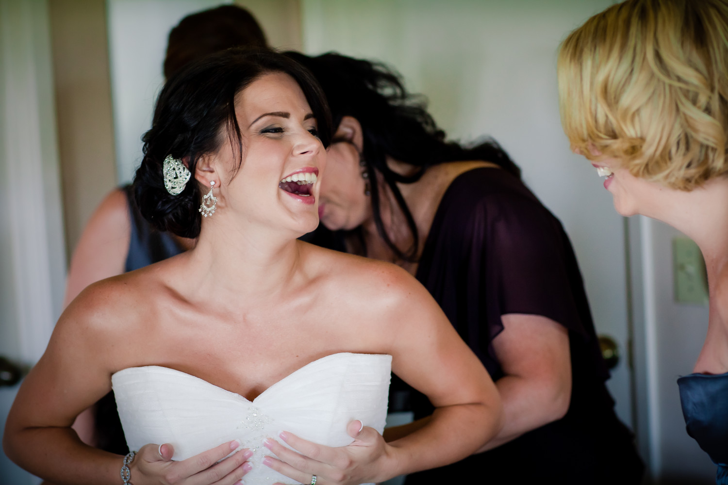 Bridal party helps bride get dressed