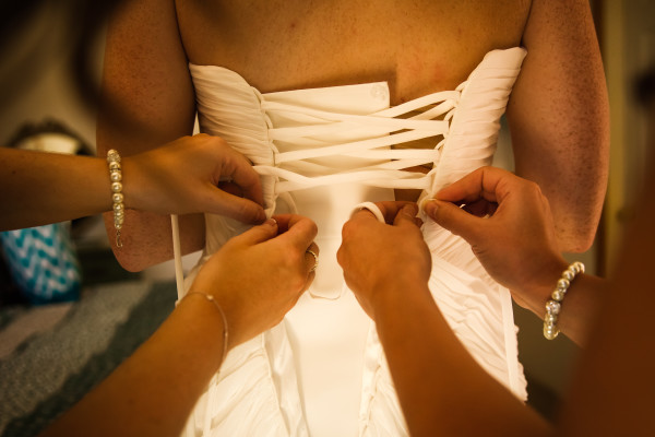 Bride puts on her wedding gown